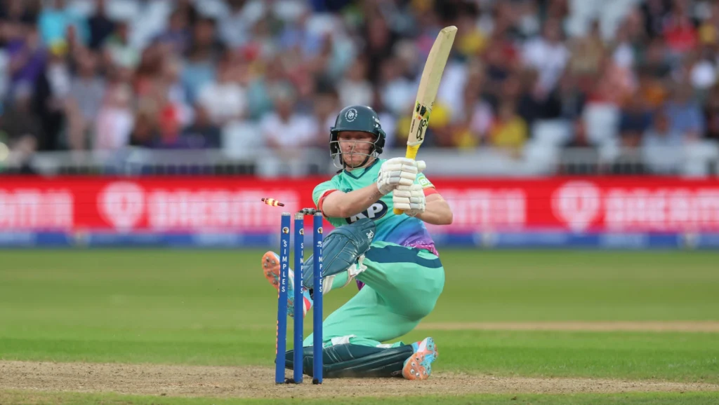A cricket player in action during a match, batting with intensity.