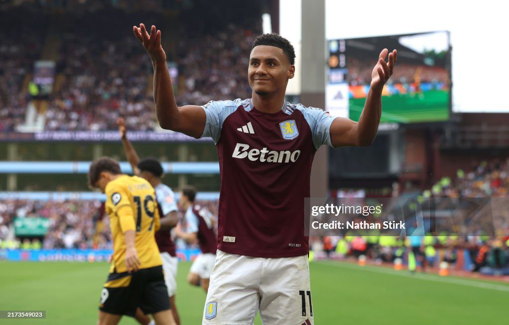 Aston Villa player celebrating a goal during a Premier League match.