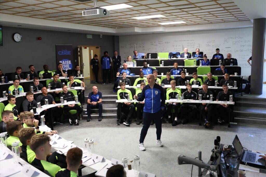A coaching session at the FA Core, with participants engaged in a learning environment.