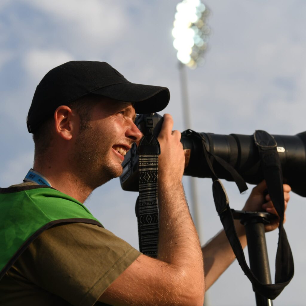 Nathan Stirk smiling while taking photos.