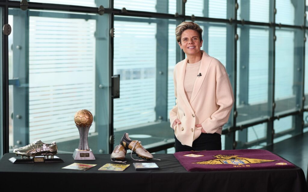 A display of football awards, including a golden boot, trophy, and signed memorabilia.