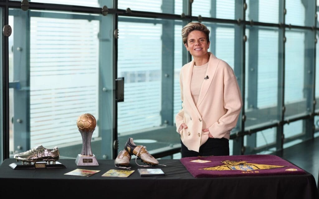 A display of football awards, including a golden boot, trophy, and signed memorabilia.