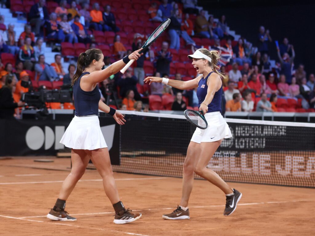 Women tennis players celebrating their success during a match.