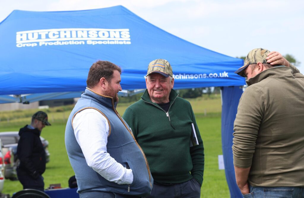 Agricultural experts engaging in conversation at a networking event.