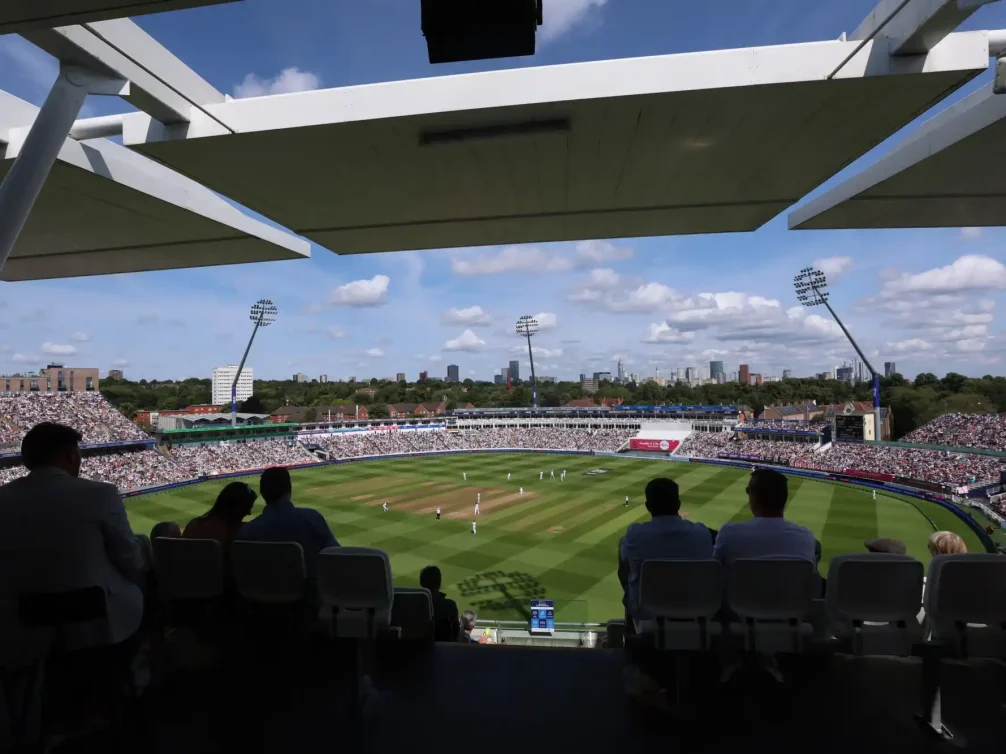A cricket match in progress at Lord's Stadium, showcasing players and the audience.