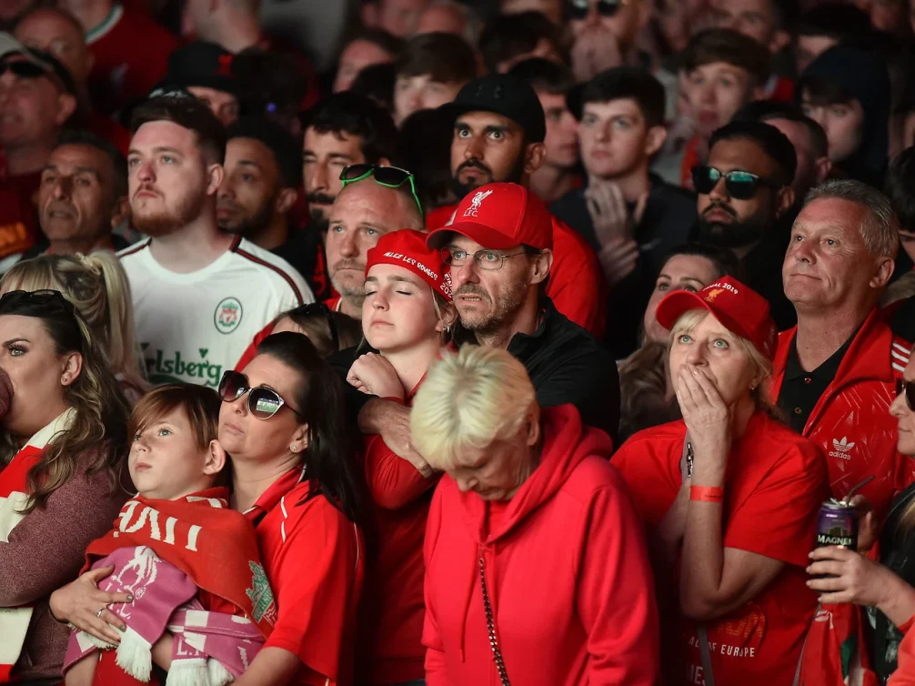 Emotional reactions from Liverpool fans at a live event.
