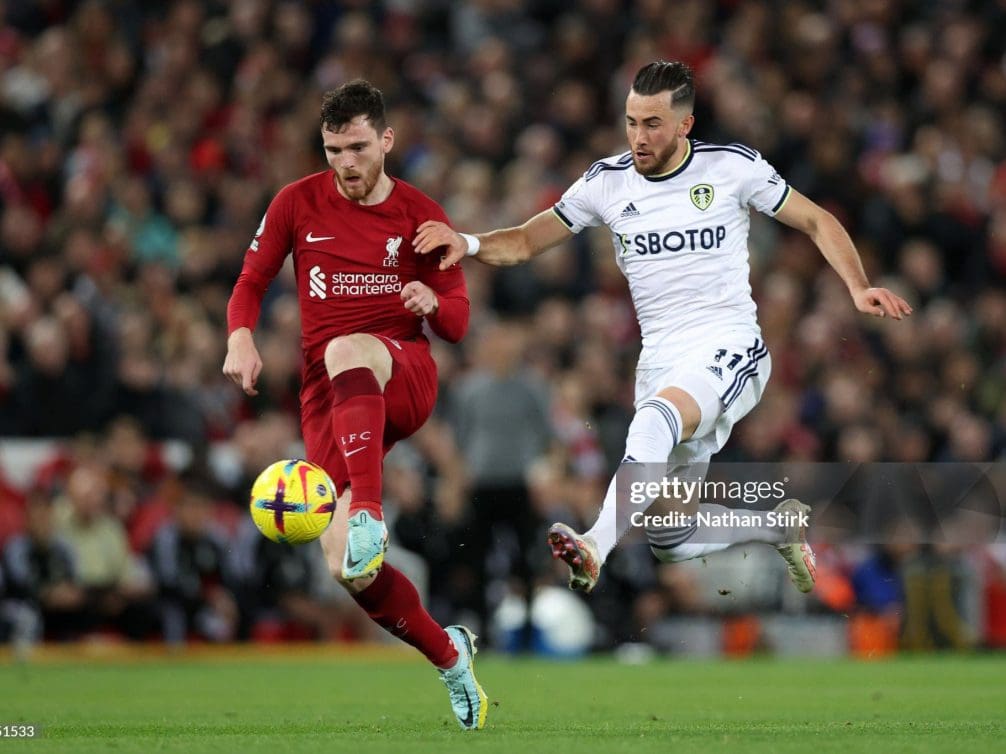 LIVERPOOL, ENGLAND - OCTOBER 29: Andy Robertson of Liverpool battles for possession with Jack Harrison of Leeds United during the Premier League match between Liverpool FC and Leeds United at Anfield on October 29, 2022 in Liverpool, England. (Photo by Nathan Stirk/Getty Images)