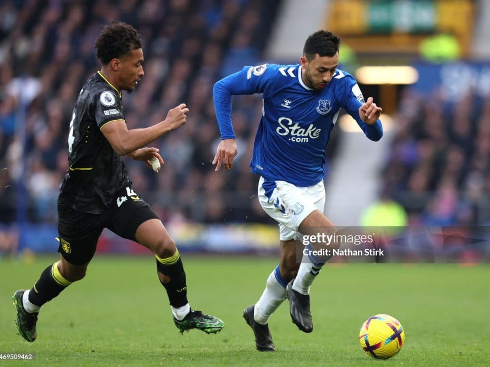 LIVERPOOL, ENGLAND - FEBRUARY 25: Dwight McNeil of Everton runs with the ball whilst under pressure from Boubacar Kamara of Aston Villa during the Premier League match between Everton FC and Aston Villa at Goodison Park on February 25, 2023 in Liverpool, England. (Photo by Nathan Stirk/Getty Images)