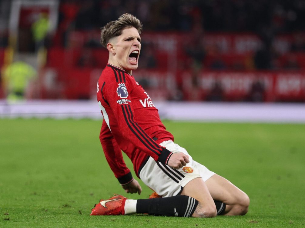 Manchester United player celebrating a goal on the pitch.
