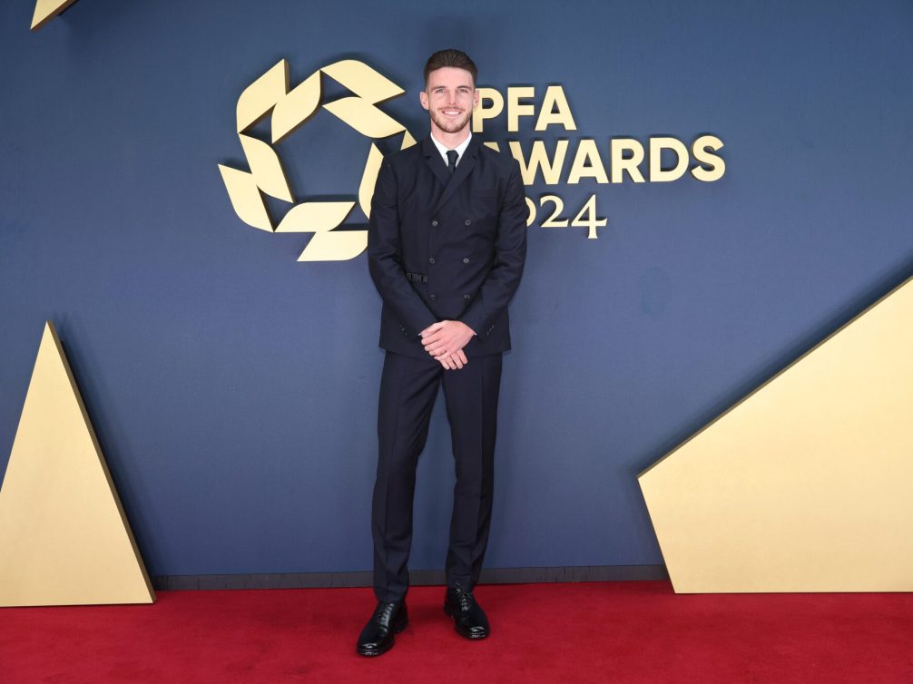 A man in a stylish suit posing on the red carpet at the PFA Awards 2024.