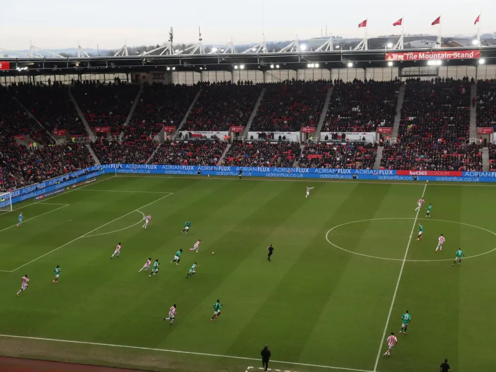 Aerial view of a Stoke City football match in a packed stadium.