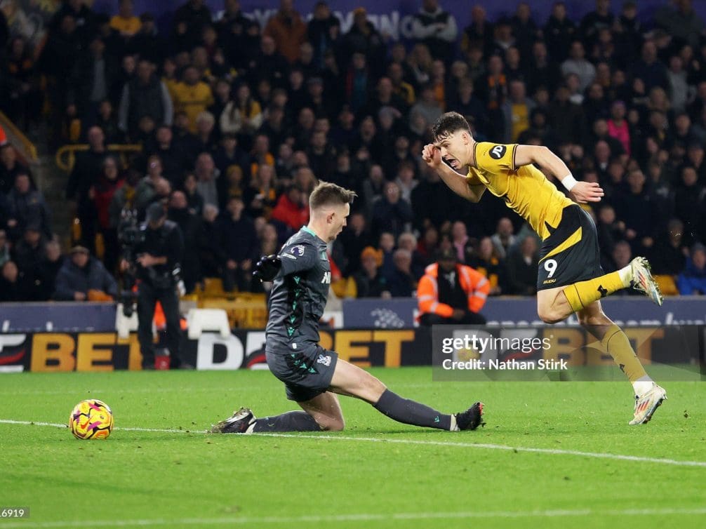 A Wolverhampton Wanderers player evading a tackle during a Premier League match.